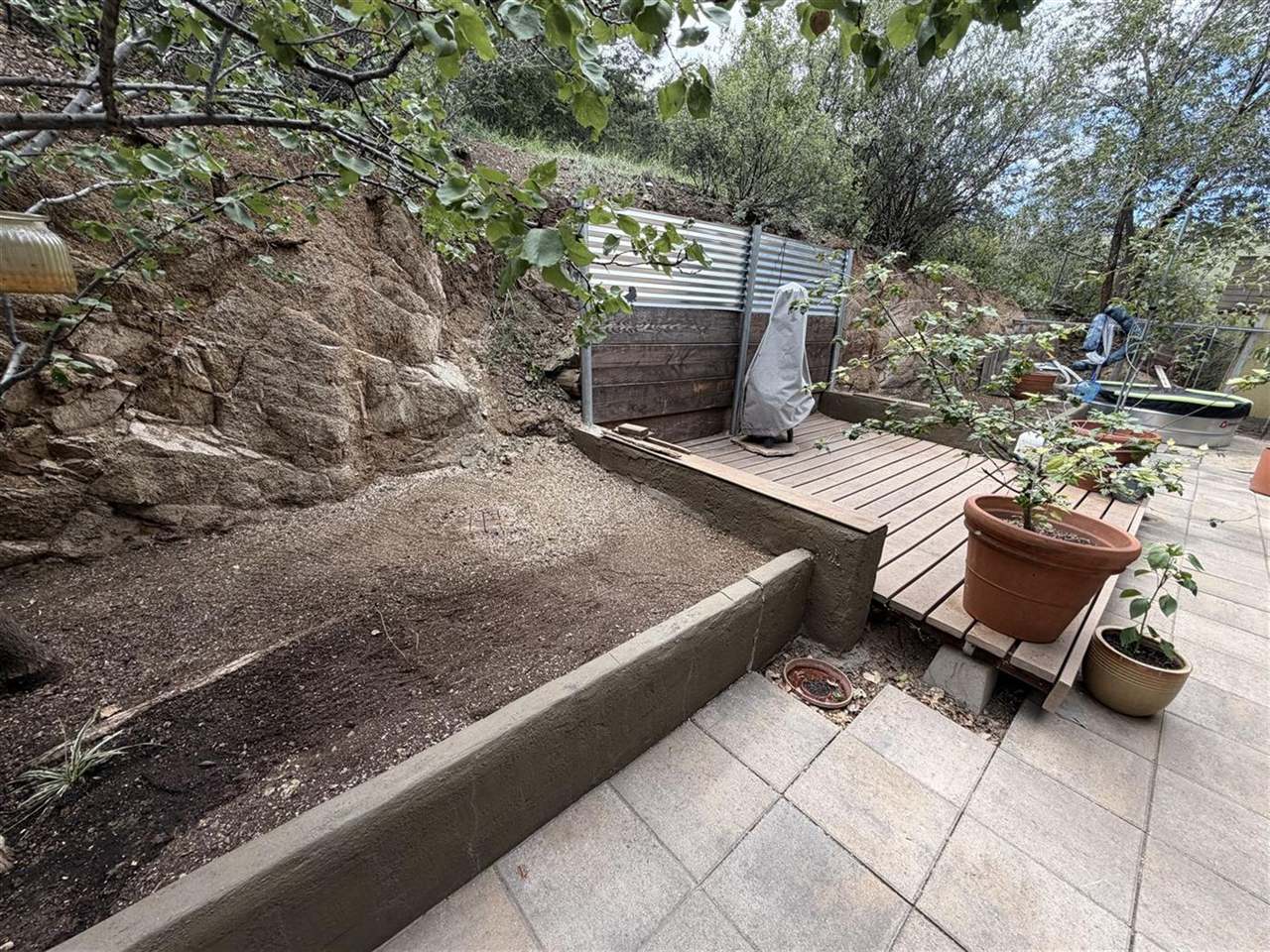 Stucco retaining wall built into a rocky hillside near Prescott
